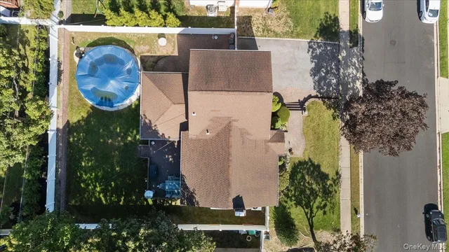 an aerial view of residential house with outdoor space and swimming pool