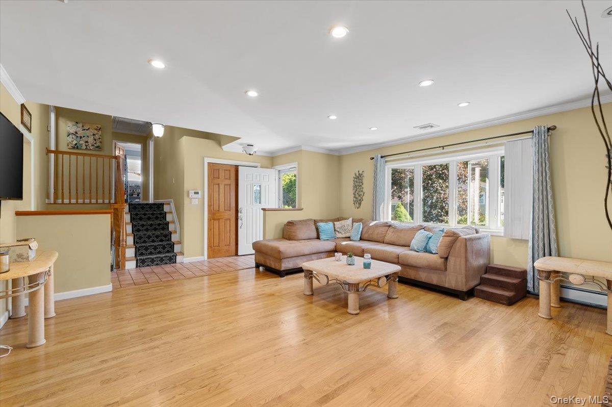 21 Eleanor Road Plainview, NY 11803 - Photo 9 of 39 a living room with furniture and wooden floor