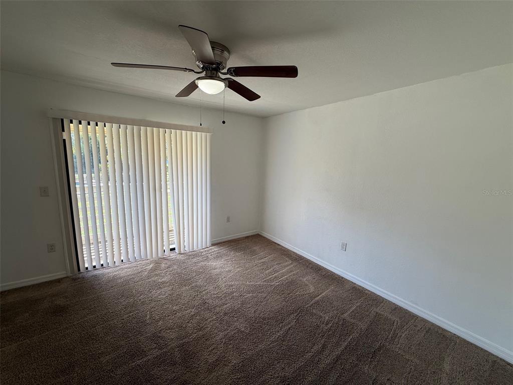 22710 Watersedge Boulevard, Unit 73 Land O' Lakes, FL 34639 - Photo 12 of 39 an empty room with a ceiling fan and window