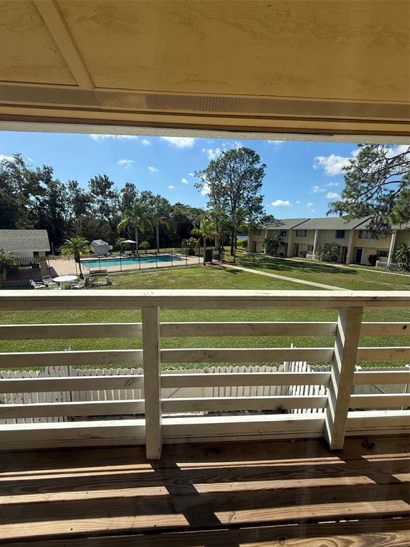 22710 Watersedge Boulevard, Unit 73 Land O' Lakes, FL 34639 - Photo 17 of 39 a view of a swimming pool with a table and chairs under an umbrella
