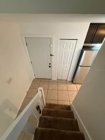 a view of a lake with lawn chairs and an umbrella