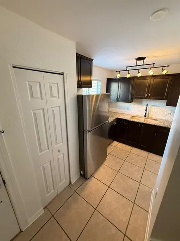 a view of a chair and table in the backyard