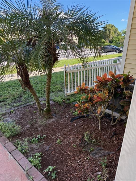 22710 Watersedge Boulevard, Unit 73 Land O' Lakes, FL 34639 - Photo 27 of 39 a view of a chair and table in the backyard