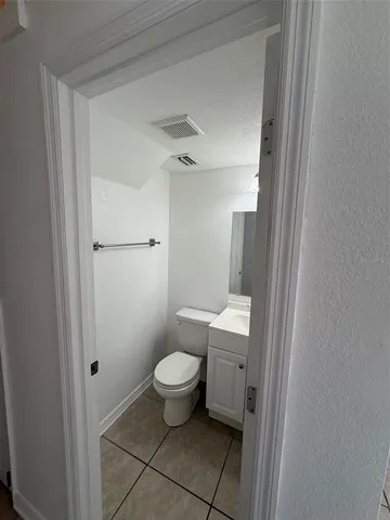 a bathroom with a toilet sink and a mirror