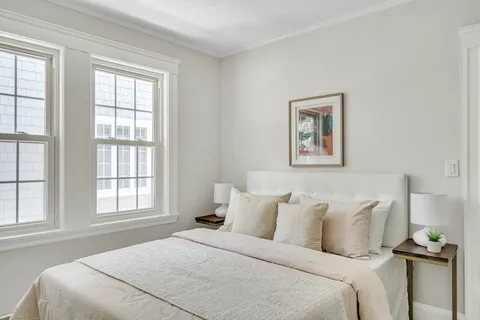 a bedroom with bed and window