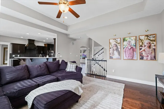 a living room with furniture and kitchen view