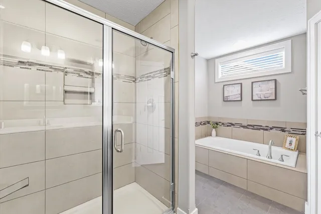 a bathroom with a bathtub and a shower
