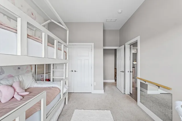 a bedroom with a bed and cabinets