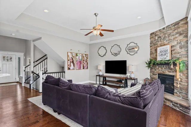 a living room with furniture a flat screen tv and a fireplace