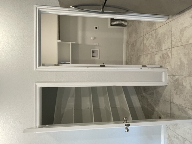 12401 Amber Lynn Path Manor, TX 78653 - Photo 5 of 33 Functional laundry nook provides utility and storage in one convenient space.
