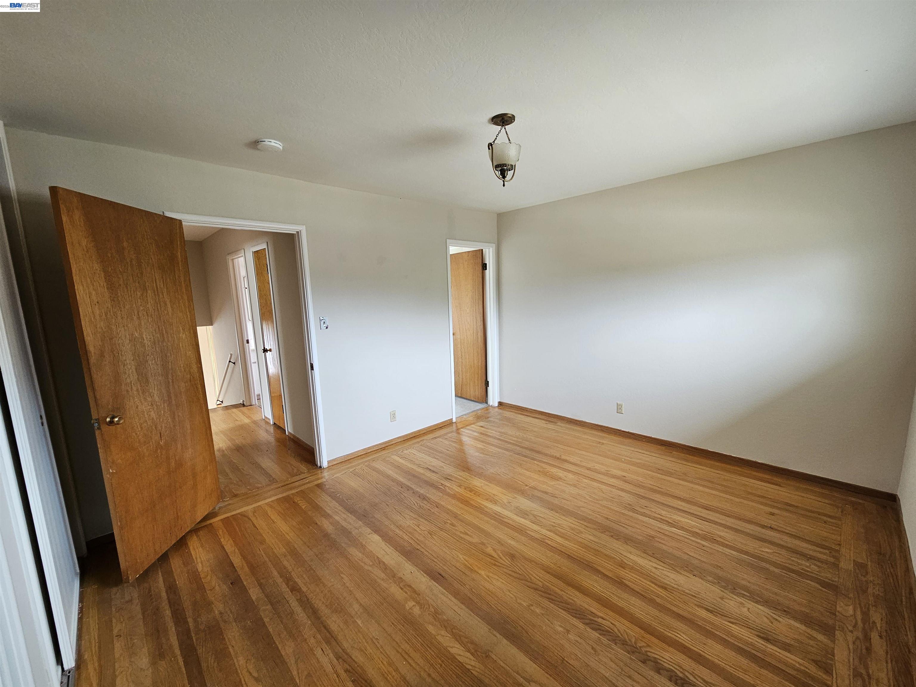 18758 Crane Avenue Castro Valley, CA 94546 - Photo 7 of 13 an empty room with wooden floor and entrance