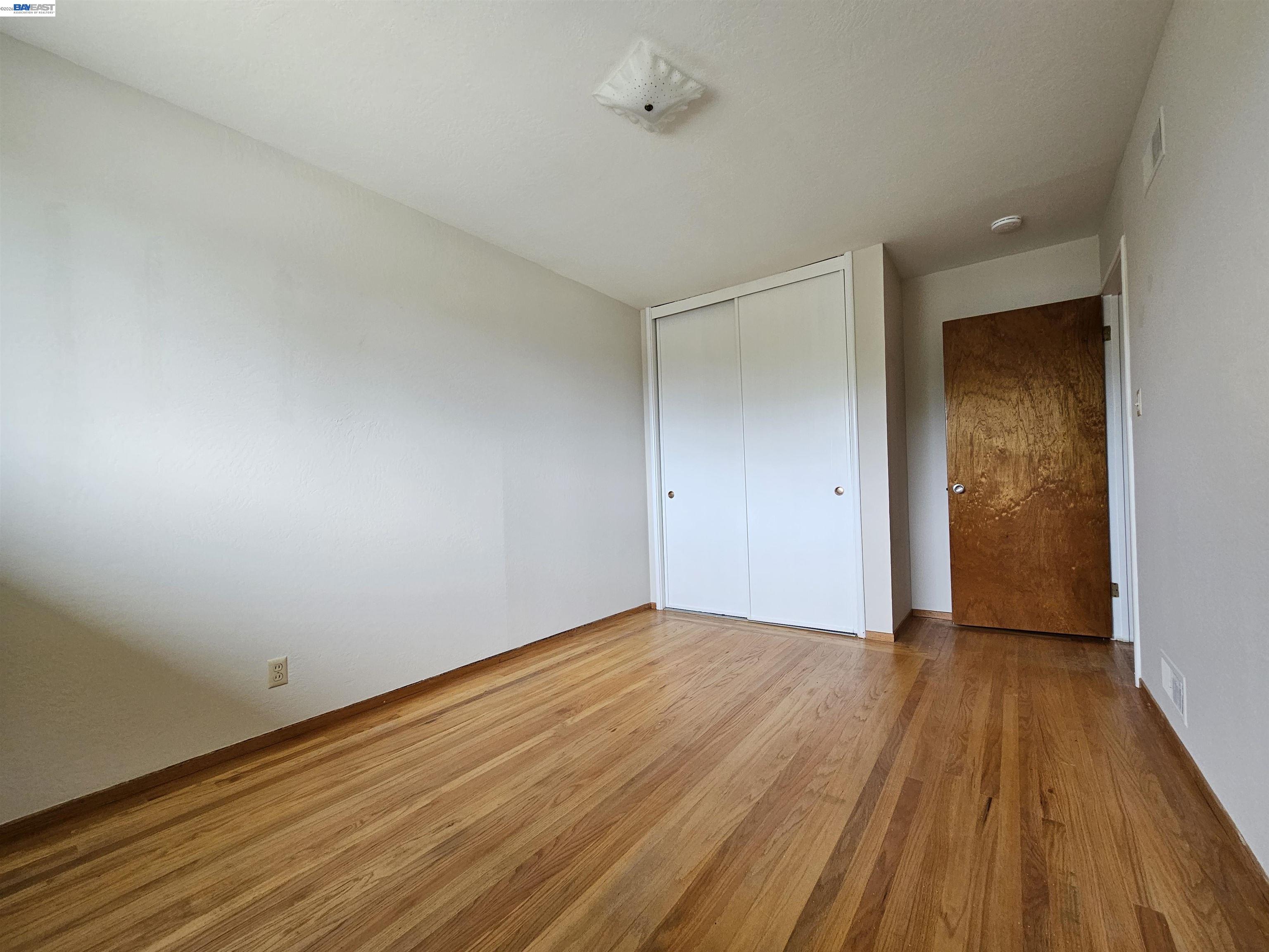 18758 Crane Avenue Castro Valley, CA 94546 - Photo 10 of 13 a view of an empty room with wooden floor and a window
