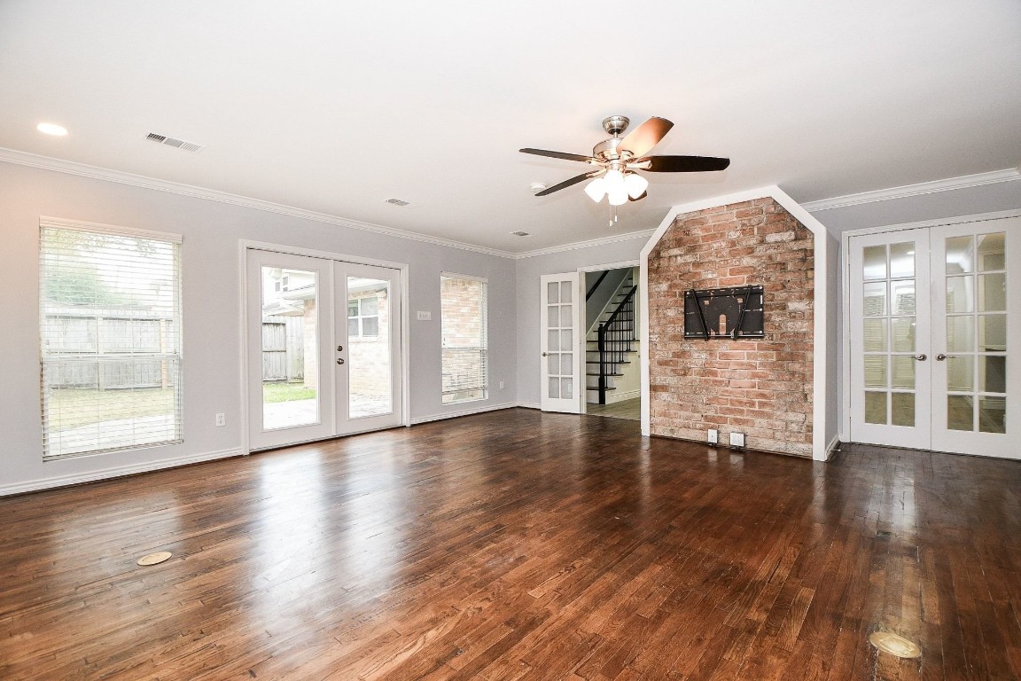 14011 Wickersham Lane Houston, TX 77077 - Photo 16 of 38 a view of a livingroom with wooden floor and a ceiling fan