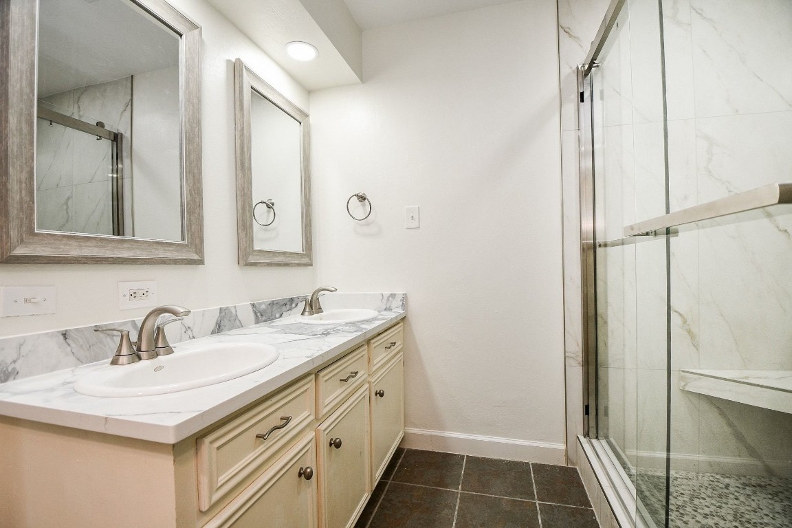 14011 Wickersham Lane Houston, TX 77077 - Photo 23 of 38 a bathroom with a sink and a mirror