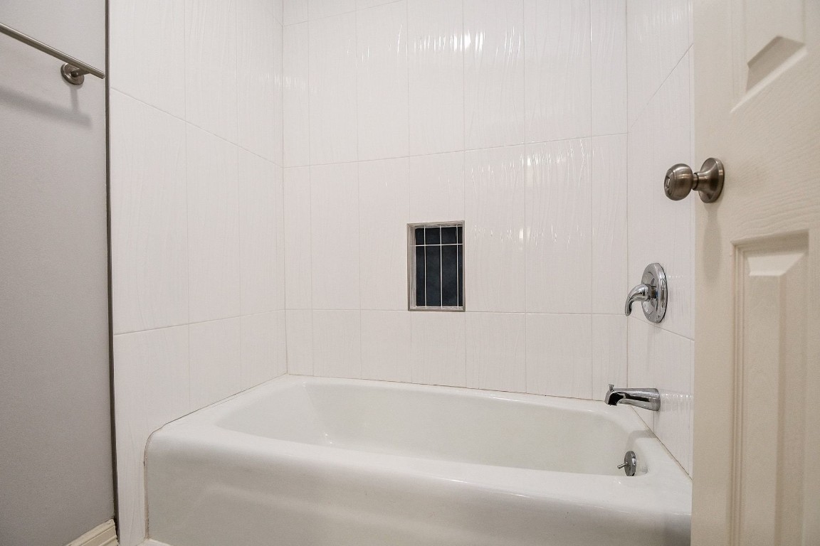 14011 Wickersham Lane Houston, TX 77077 - Photo 30 of 38 a bathroom with a tub