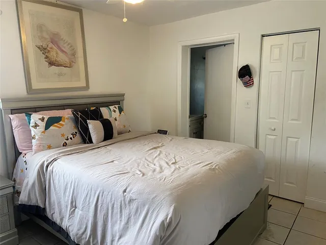 a bedroom with a bed and a painting on the wall