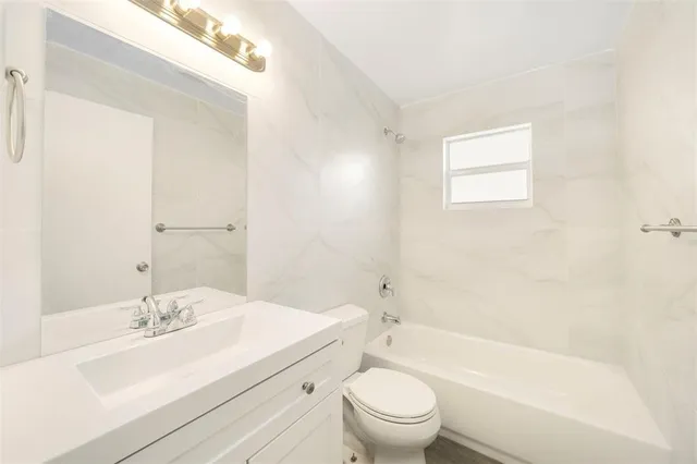 a bathroom with a sink a toilet and a bathtub