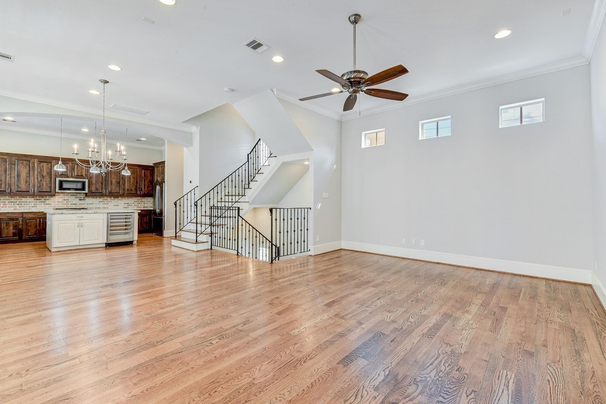 4506 Jackson Street Houston, TX 77004 - Photo 21 of 29 a view of a room with wooden floor ceiling fan and windows