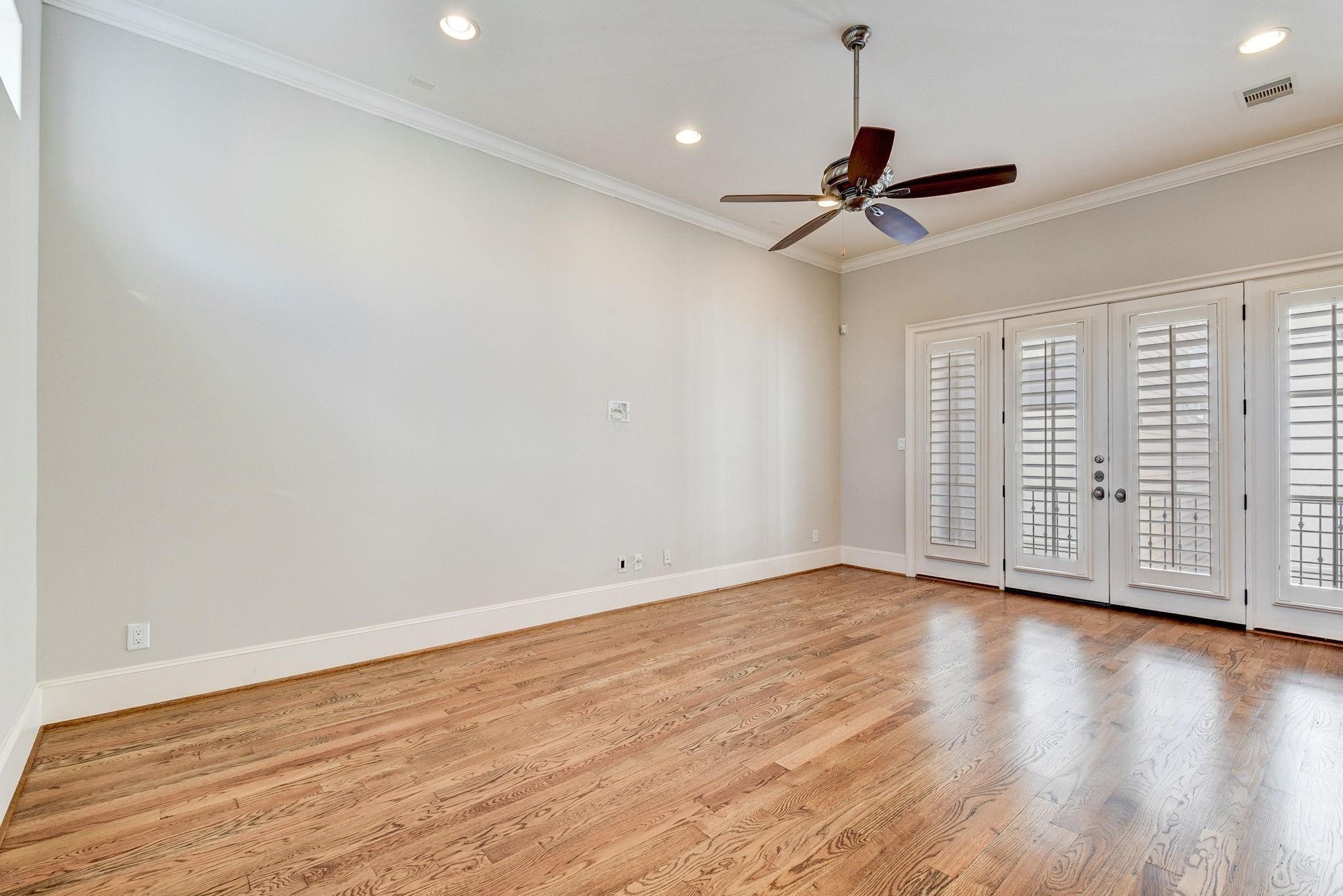 4506 Jackson Street Houston, TX 77004 - Photo 23 of 29 a view of an empty room with wooden floor ceiling fan
