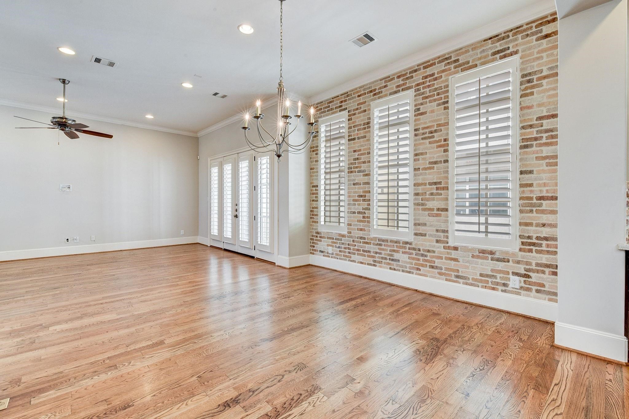 4506 Jackson Street Houston, TX 77004 - Photo 25 of 29 an empty room with wooden floor and large windows
