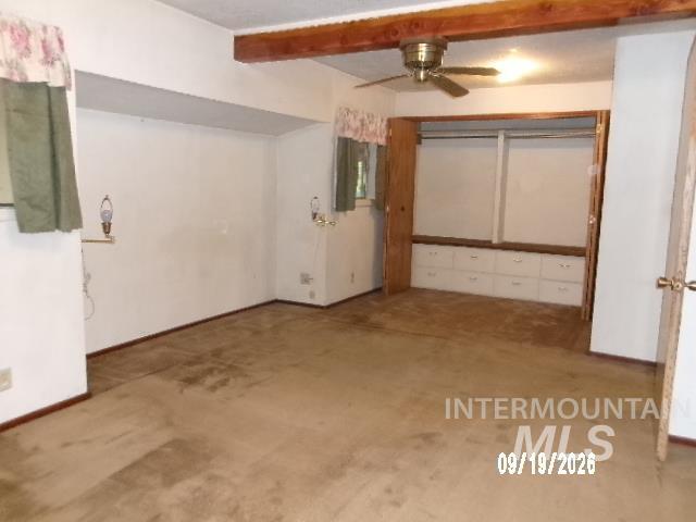 31997 2nd Fork Road Ola, ID 83657 - Photo 18 of 47 Exposed wood beam ceiling, ceiling fan with integrated lighting, built-in wardrobe with shelving and drawers, built-in wall niche, and carpeted flooring