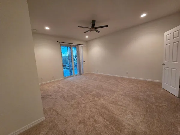 an empty room with closet and windows