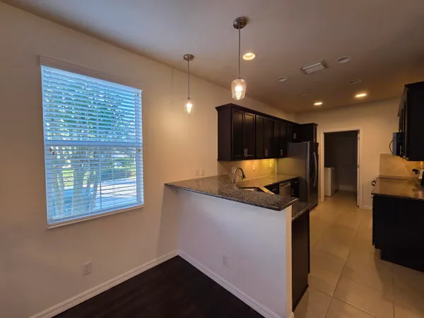 a kitchen with stainless steel appliances granite countertop a sink and a microwave
