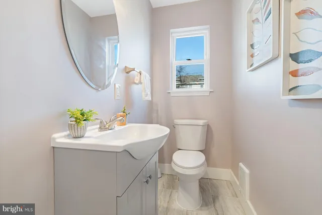 a white sink sitting next to a white toilet