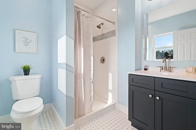 a bathroom with a toilet a sink and a mirror