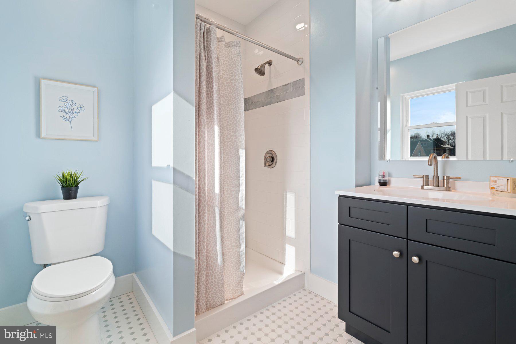 3704 Egerton Road Baltimore, MD 21215 - Photo 15 of 32 a bathroom with a toilet a sink and a mirror