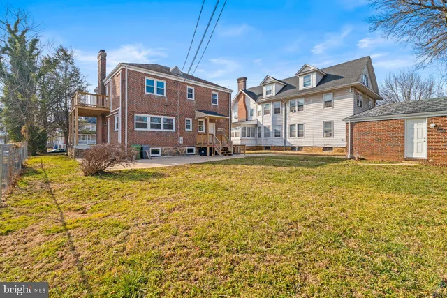 a house view with swimming pool in front of it