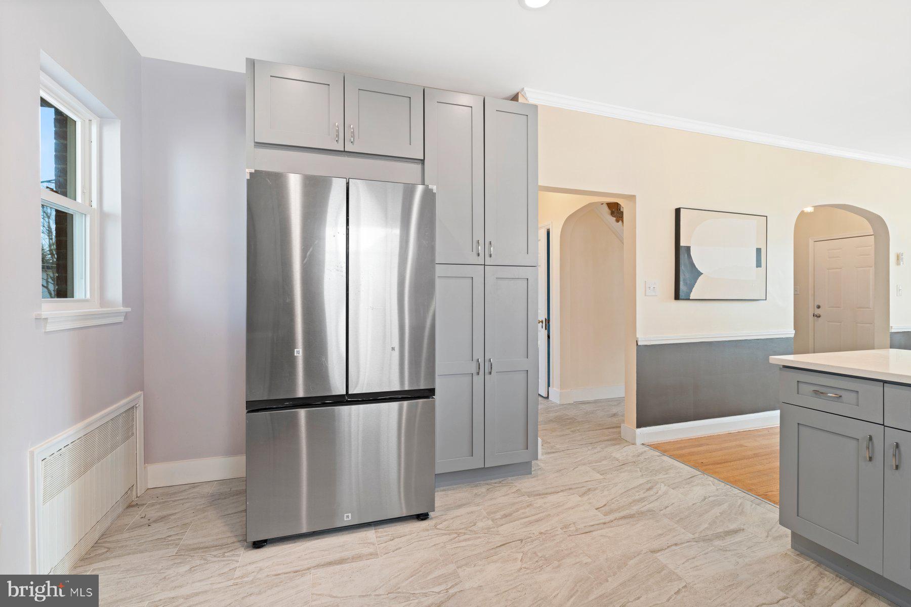 3704 Egerton Road Baltimore, MD 21215 - Photo 10 of 32 a kitchen with granite countertop stainless steel appliances a refrigerator and cabinets