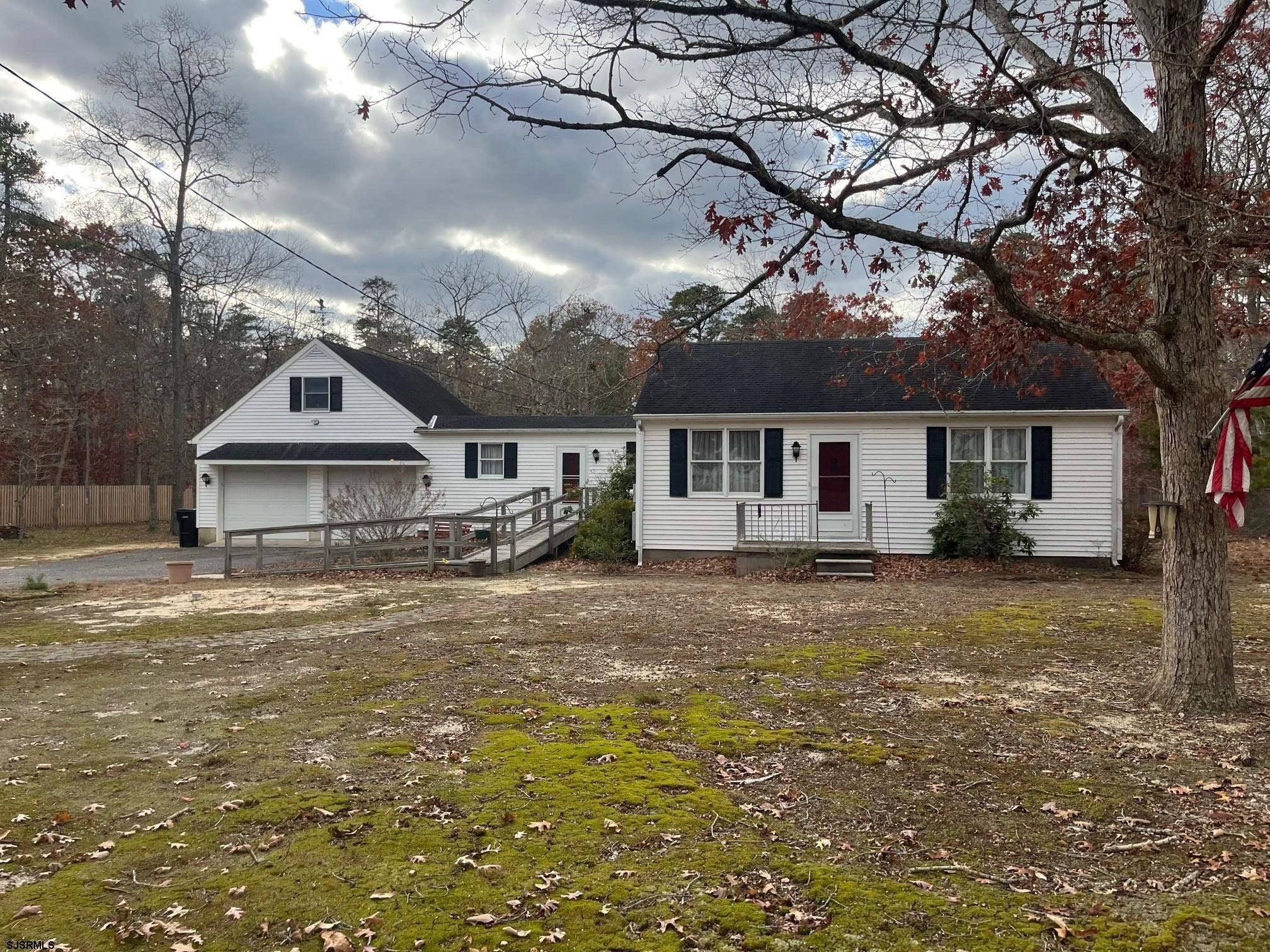 a front view of a house with a garden and yard