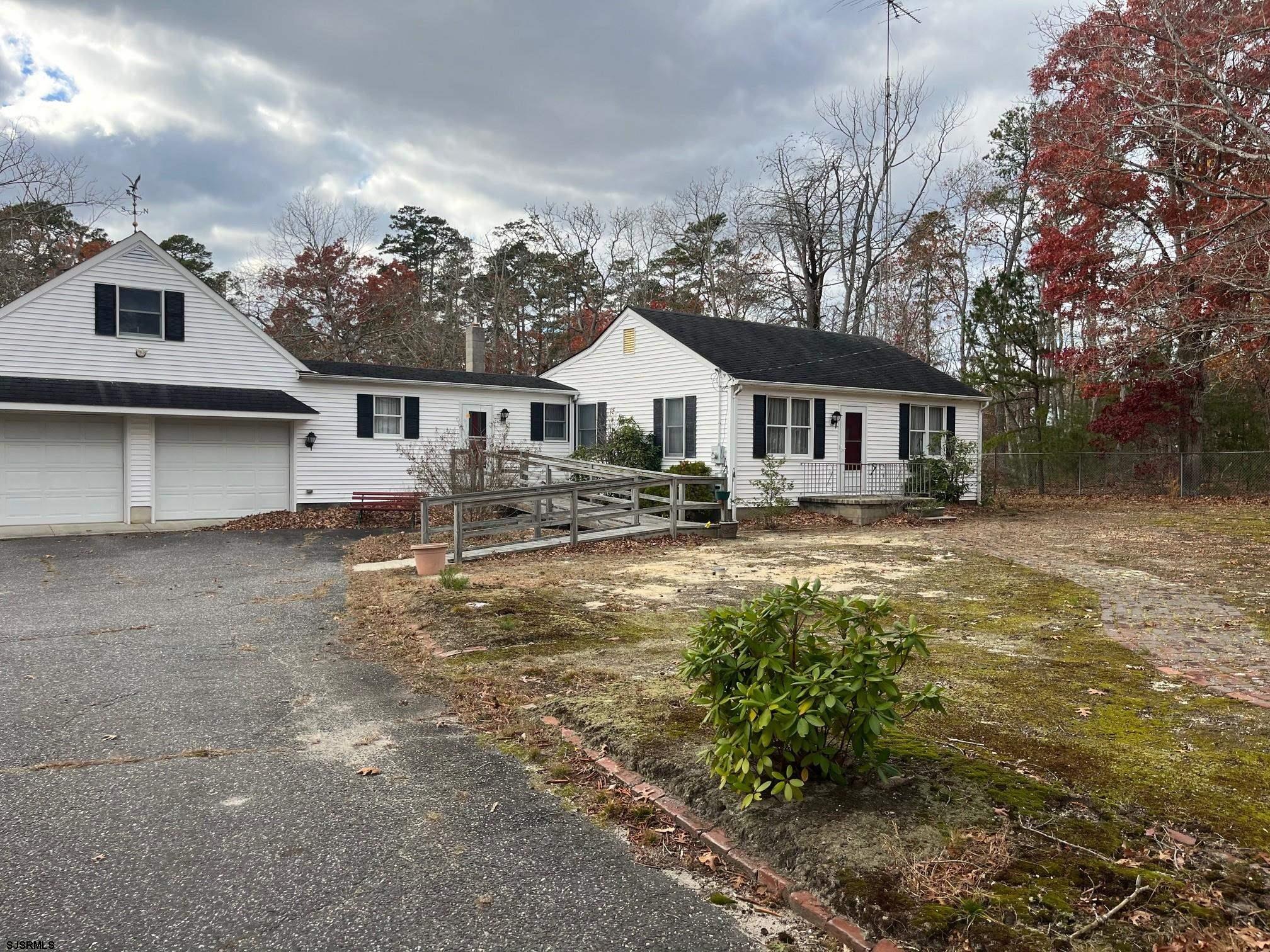 124 Butter Road Ocean View, NJ 08230 - Photo 3 of 5 a front view of a house with a yard table and chairs