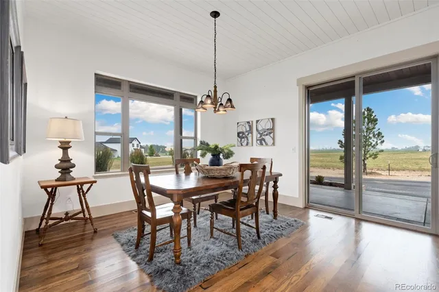a living room with furniture and kitchen