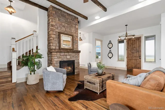 a living room with furniture and a chandelier