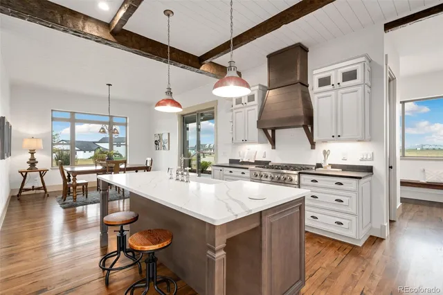 a kitchen with a sink a stove and cabinets