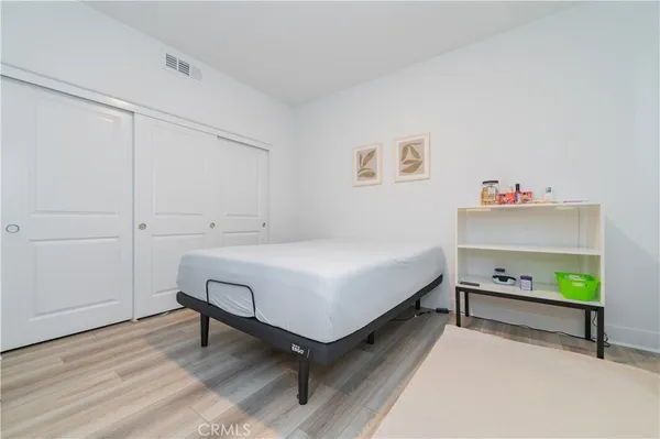 a bedroom with a bed and a dresser