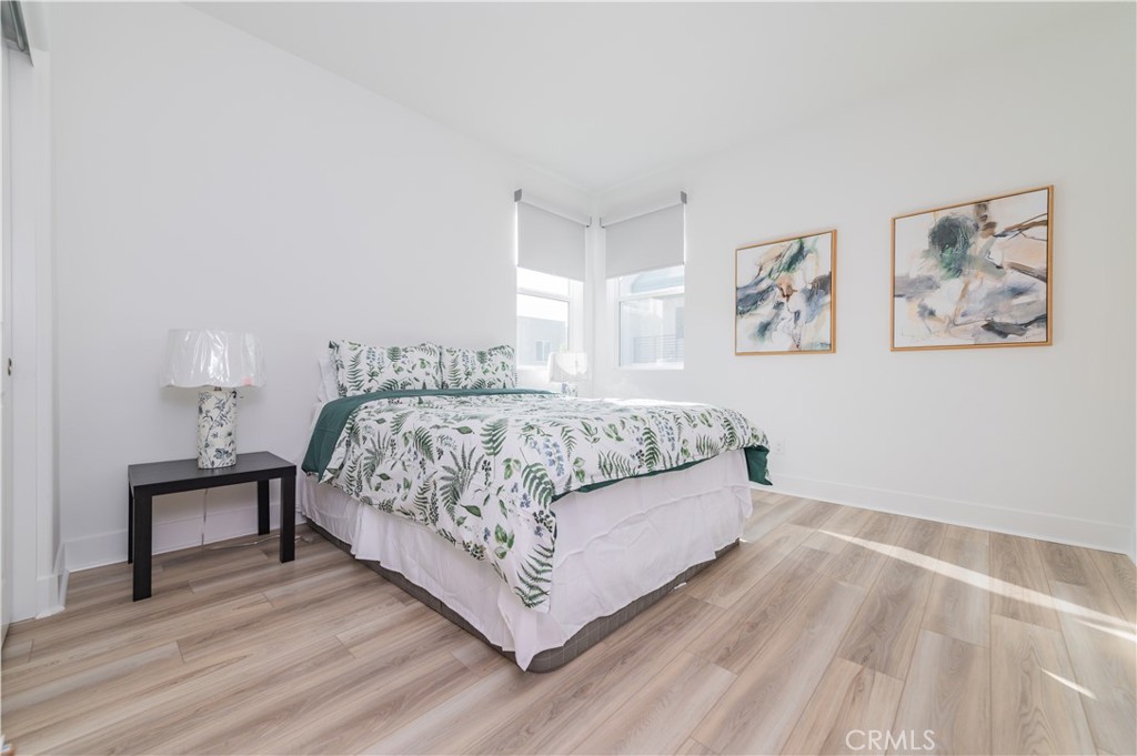 168 Sash Irvine, CA 92618 - Photo 23 of 31 a bedroom with a bed paintings on the wall and a window