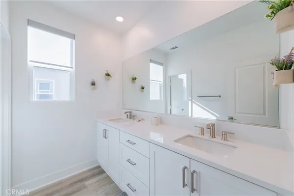 a bathroom with 2 sink tub and a mirror