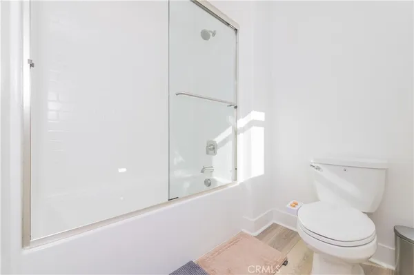 a white toilet sitting next to a bathroom sink