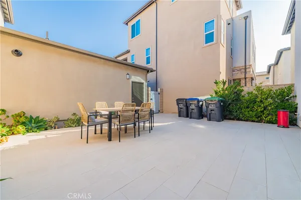 a view of a patio with a table and chairs and potted plants