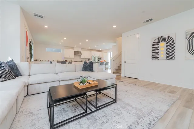 a living room with furniture and kitchen view