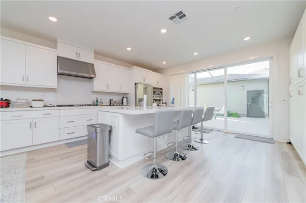 a kitchen with stainless steel appliances kitchen island granite countertop a sink and cabinets