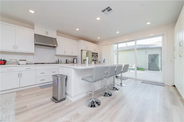 a kitchen with stainless steel appliances kitchen island granite countertop a sink and cabinets