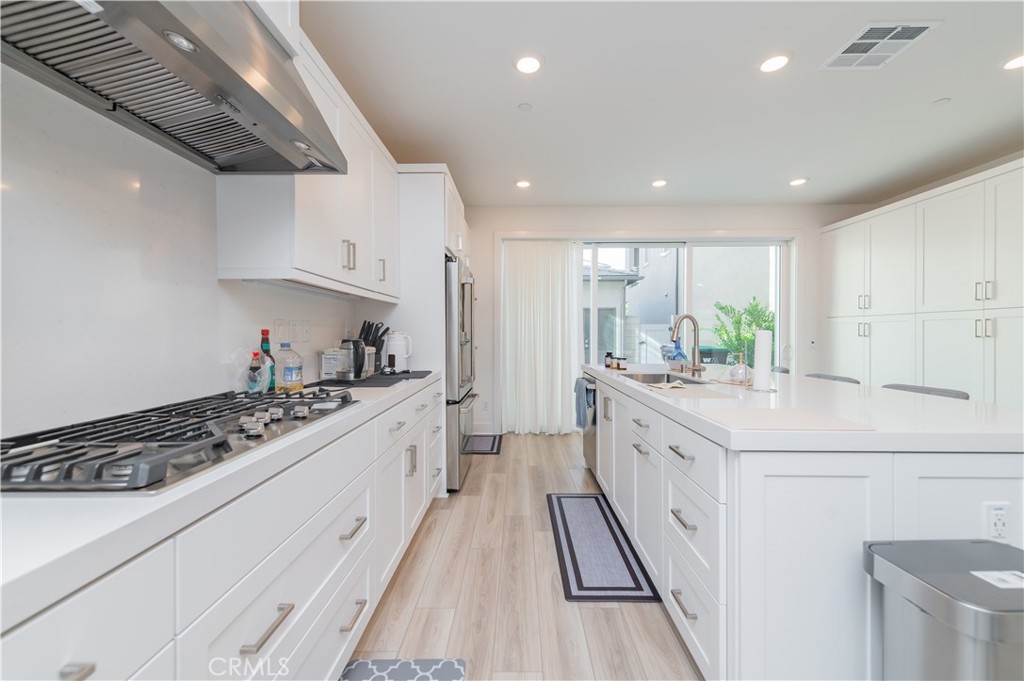 168 Sash Irvine, CA 92618 - Photo 10 of 31 a large kitchen with stainless steel appliances sink stove and cabinets