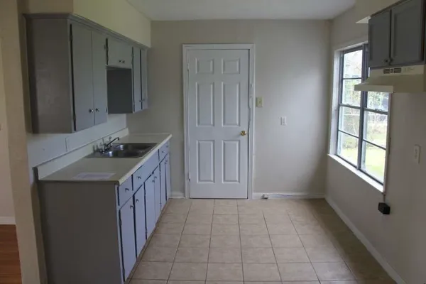 a kitchen with a sink stove and cabinets