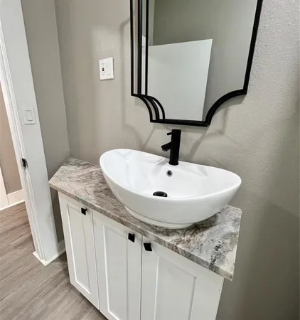 a bathroom with a sink and mirror