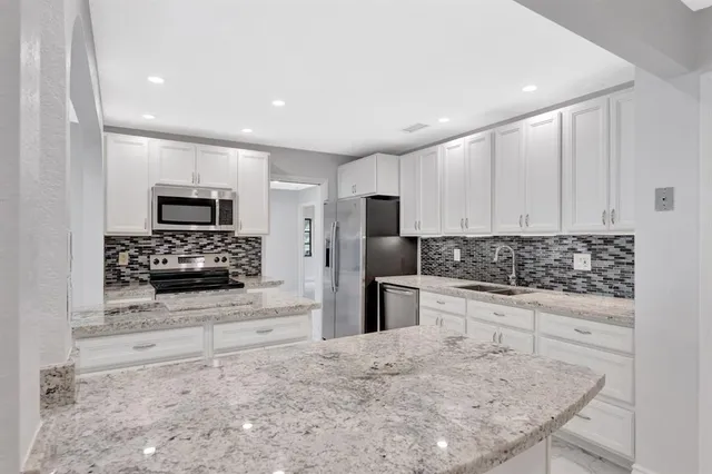 a view of a electric appliances in kitchen and empty room