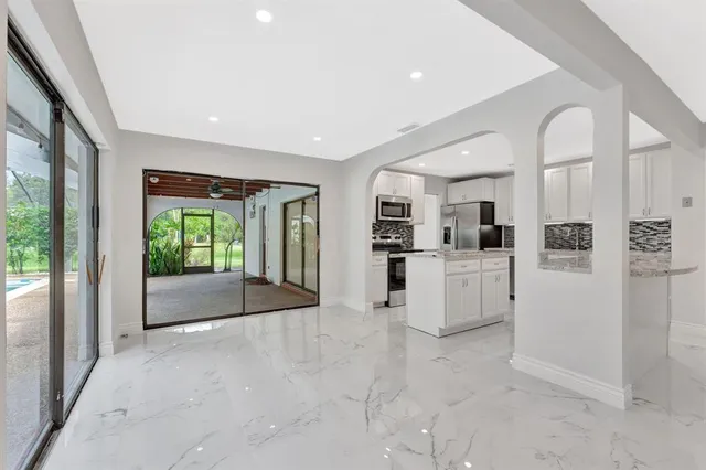 a kitchen with white cabinets and white appliances